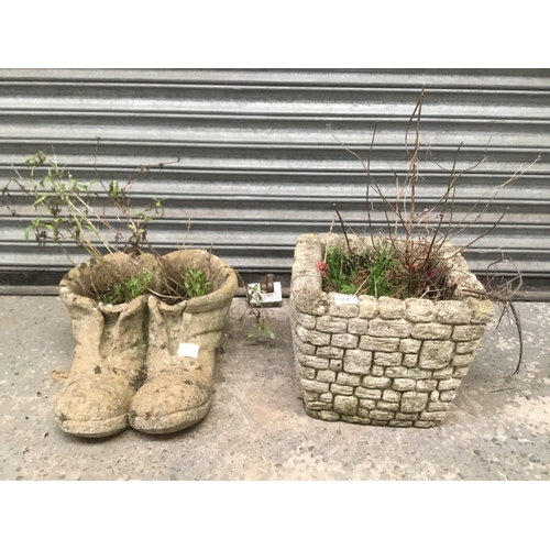 117 - Two concrete planters including a pair of boots