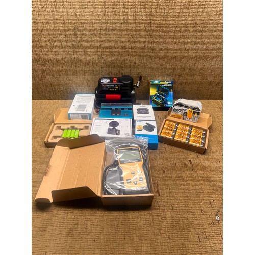 5 - Motopower MP69033 OBD2 Scanner, power inverter, batteries, and wireless headphones.