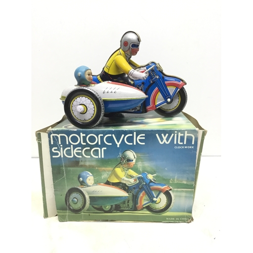 810 - Vintage boxed Tin plate wind up motor cycle with a sidecar