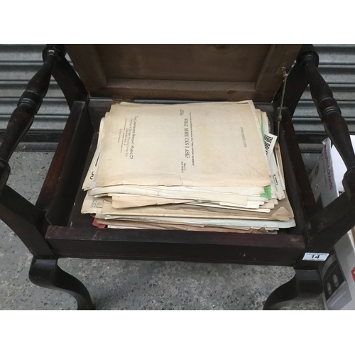 14 - A vintage piano stool with a large quantity of sheet music