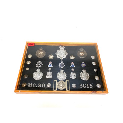 947 - Monmouth Police Constabulary memorabilia in a display case, including cap badges, shoulder titles an...