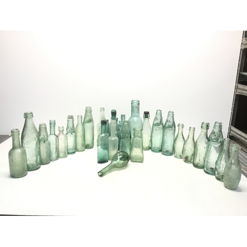 1032 - A selection of antique advertising bottles including orange crush, mineral water and chutney