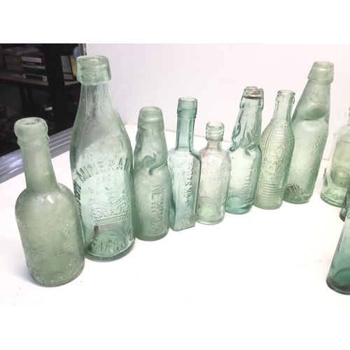 1032 - A selection of antique advertising bottles including orange crush, mineral water and chutney