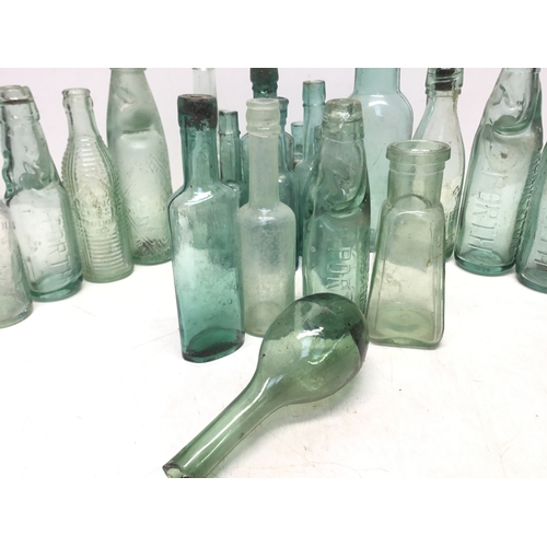 1032 - A selection of antique advertising bottles including orange crush, mineral water and chutney