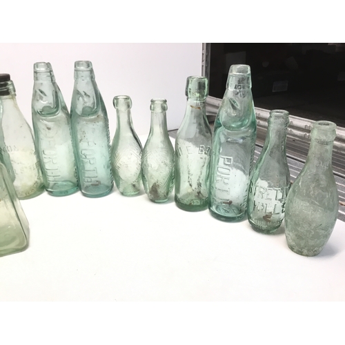 1032 - A selection of antique advertising bottles including orange crush, mineral water and chutney