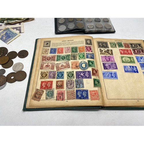 1021 - Collectible items, including World Coin Stock Full of Coins and The Victory Stamp Album with stamps.