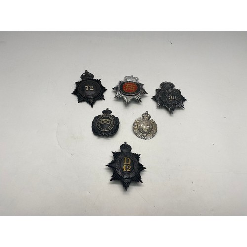 550 - Collection of six police helmet badges