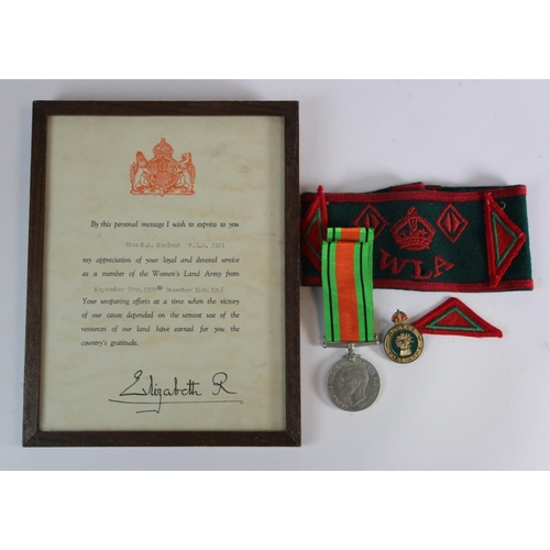 2429 - WW2 Women's Land Army arm band Defence medal badges and framed service scroll etc., to Miss A A Garl... 