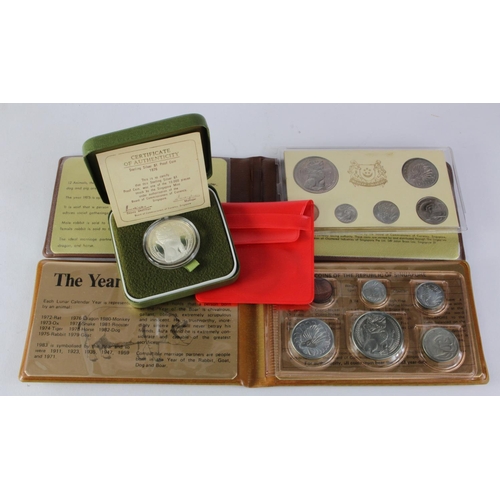 539 - Singapore: Mint Set 1975 (some splitting inside wallet), Mint Set 1983, Silver Proof $1 1976 lightly... 