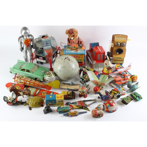 101 - Tinplate toys. A collection of approximately twenty-five original and reproduction tinplate toys, in... 