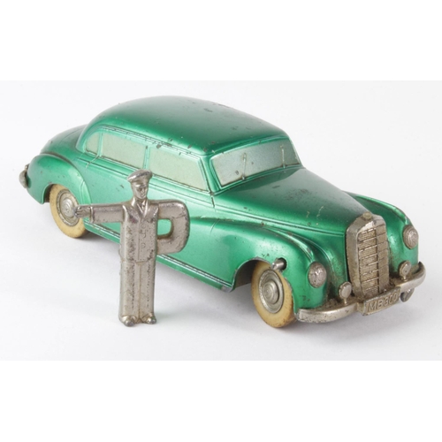 94 - Prameta Mercedes Benz 300 green clockwork toy, with original key depicting a chauffeur, in need of s... 