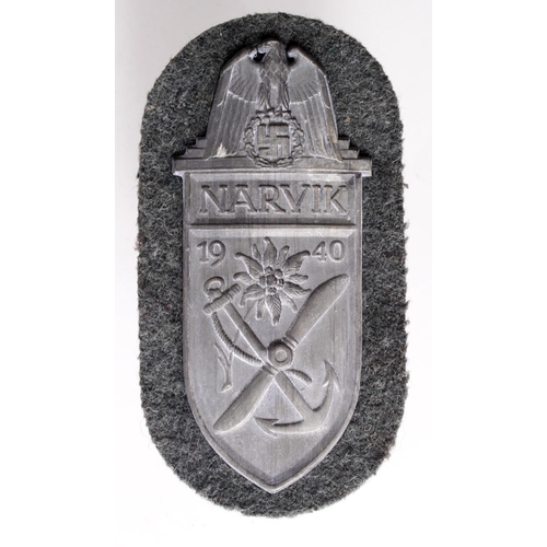 1197 - German 1940 Narvic arm shield with backing plate.