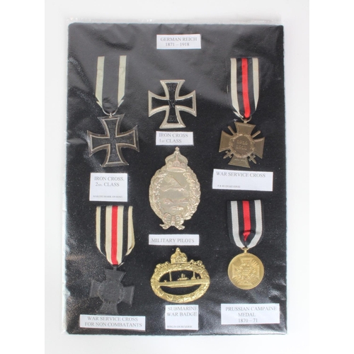 1288 - German WW1 medals and badges mounted on black. Note: items high quality replicas. (7)