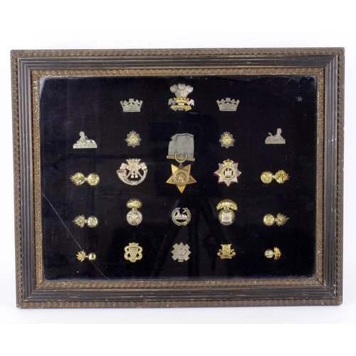 1403 - Large glazed frame of various Cap Badges, Collars, and a Khedives Star 1882. (Glass damaged). (x21 b... 