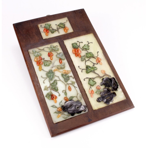 1043 - Three decorative jade plaques mounted into a single board, circa late 19th Century (?), total size 1... 