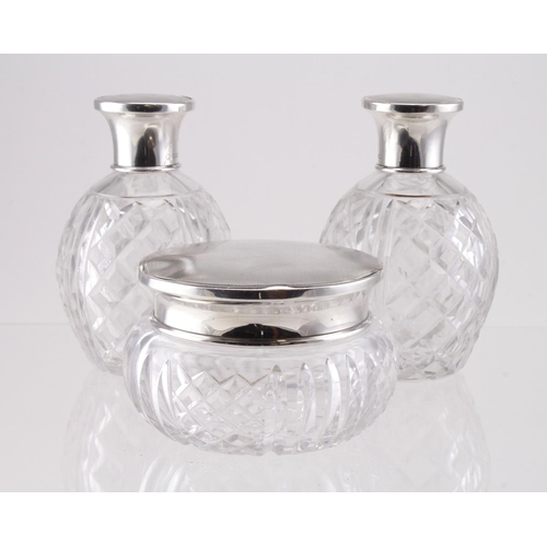 601 - Three silver topped cut glass scent bottles & jar, hallmarked 'Mappin & Webb, London 1945', largest ... 