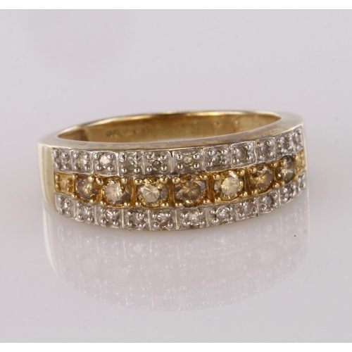 74 - 9ct yellow gold ring set with a central row of champagne coloured diamonds bordered either side by c... 