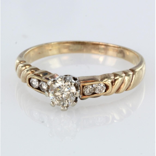 75 - 9ct yellow gold diamond solitaire ring with channel diamond set shoulders, principal diamond weight ... 