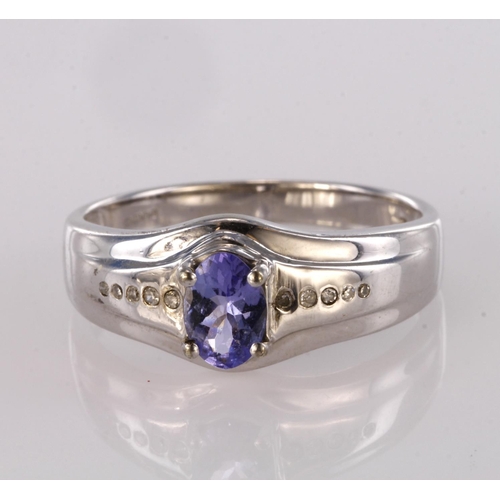 96 - 9ct white gold band ring set with oval tanzanite and diamond accents, finger size U, weight 4.1g