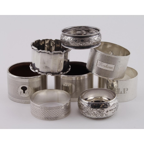 529 - Six silver napkin rings and two silver & wood napkin rings, various dates and hallmarks;  the hallma... 