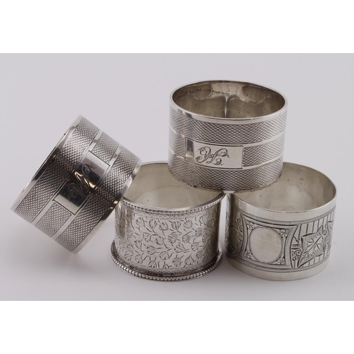 562 - Four silver napkin rings comprising two decorated Victorian rings hallmarked Birm, 1881 and London, ... 