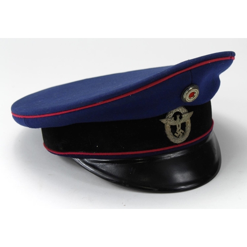 601 - German Nazi blue cloth Postal Service peaked cap with red piping and cap badge