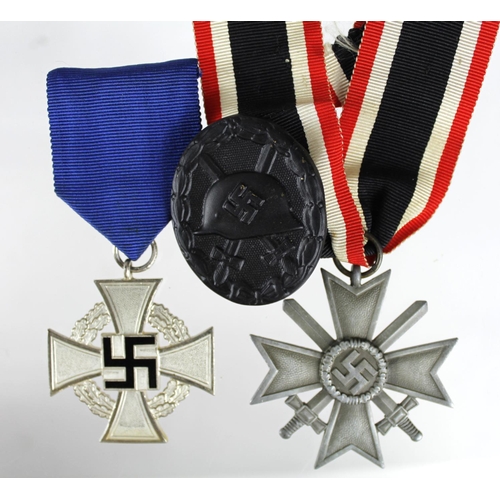 693 - German Nazi War Merit Cross with Swords, Black Wounds Badge, and 25 Years Faithful Service Medal. (3... 