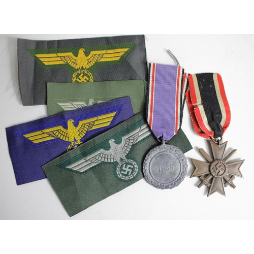 760 - German War Merit cross 2nd class with Luftschutz medal and four German cloth breast eagles