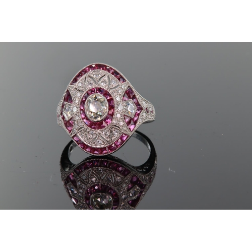 10 - Platinum ruby and diamond ring comprising a central oval diamond weighing 0.49ct surrounded by a row... 