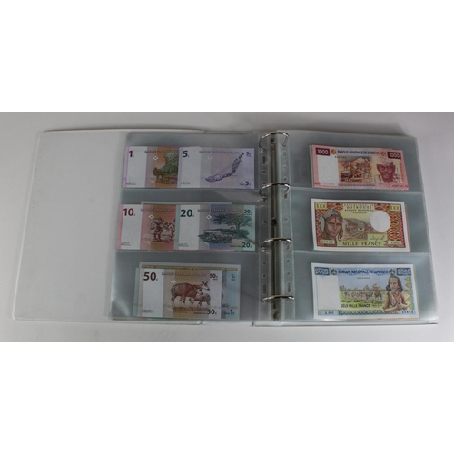 905 - World, Africa (151) a superb collection of Uncirculated notes in an album, Algeria, Angola, Biafra, ... 