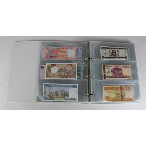 905 - World, Africa (151) a superb collection of Uncirculated notes in an album, Algeria, Angola, Biafra, ... 