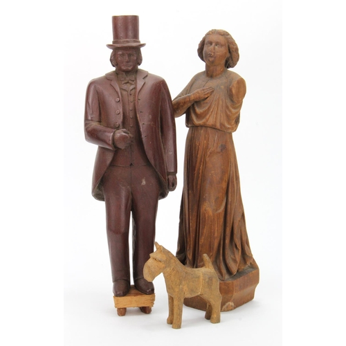 1008 - Three carved figures by Harold Pepper, depicting a gentleman in a top hat, a lady in a flowing dress... 