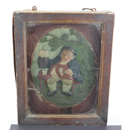 1009 - Toby jug interest. An unusual C.19thC framed oval pottery plaque depicting Toby Fillpot smoking a pi... 