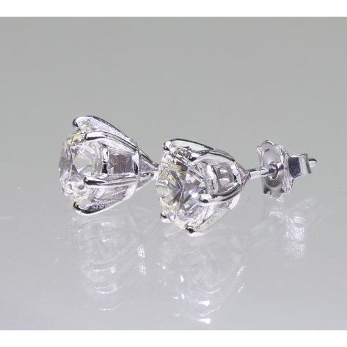 113 - 18ct white gold diamond solitaire stud earrings, two round brilliant cut diamonds with a known total... 