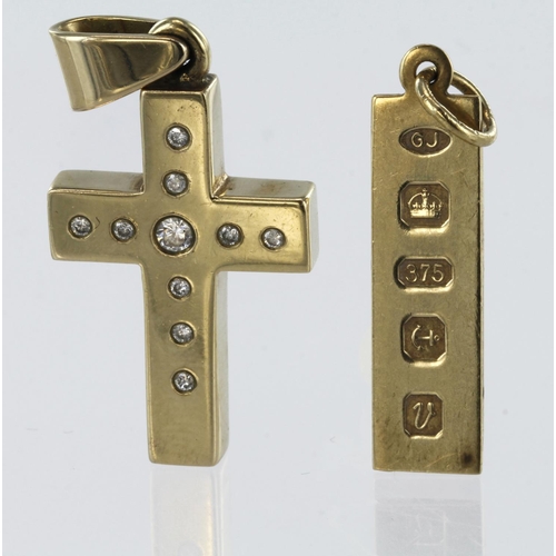 157 - Yellow gold cross pendant measuring approx. 3.5cm x 1.5cm, set with ten round brilliant cut diamonds... 