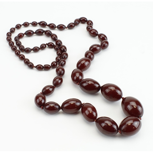 210 - Long continuous row of graduated oval bakelite beads sometimes called 