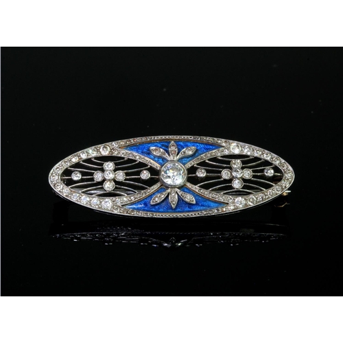 220 - Platinum and 18ct yellow gold elongated oval brooch set with a principal round old cut diamond calcu... 