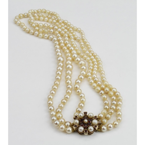 221 - Necklace consisting of three rows of graduated cultured pearls strung knotted on a 9ct yellow gold g... 