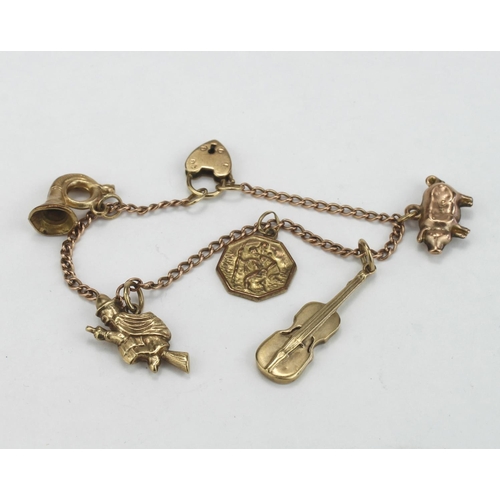 222 - 9ct / yellow metal charm bracelet with five charms attached, probably made for a child. Total weight... 