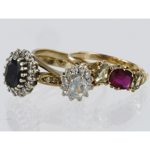 242 - 9ct yellow gold sapphire and diamond cluster ring, blue topaz cluster ring and ruby set band ring, w... 