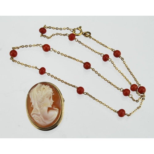 271 - 9ct yellow gold chain necklace with thirteen round coral beads spaced evenly around the entire lengt... 