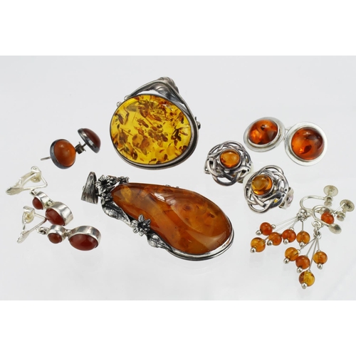 274 - Amber in silver/white metal. Includes brooches, earrings, pendant etc.