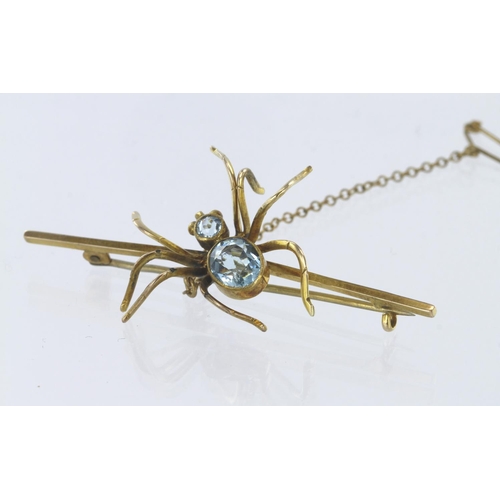 287 - 9ct yellow gold spider bar brooch with safety chain set with oval and round blue topaz, length 6cm, ... 