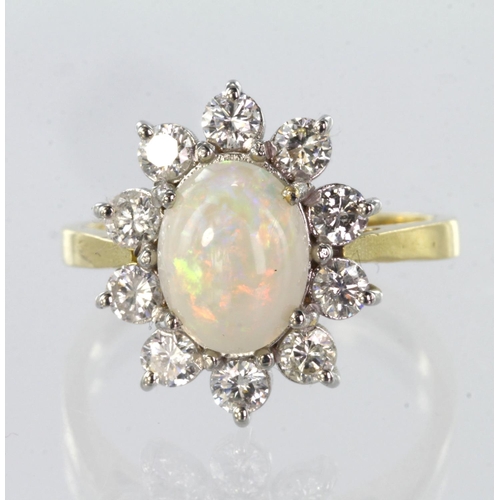 68 - 18ct yellow gold opal and diamond cluster ring set with a central oval opal measuring approx. 8mm x ... 