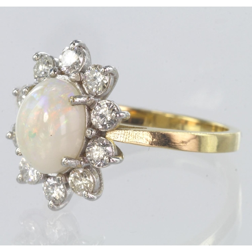 68 - 18ct yellow gold opal and diamond cluster ring set with a central oval opal measuring approx. 8mm x ... 