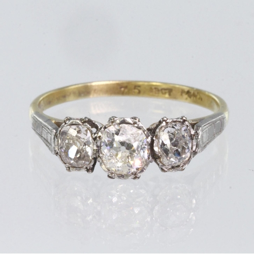 69 - 18ct yellow gold and platinum three stone ring set with central oval old cut diamond calculated as w... 