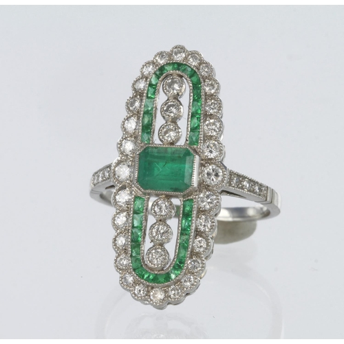 70 - 18ct white gold elongated oval emerald and diamond Art Deco style ring featuring a central rectangul... 