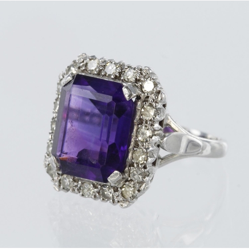 76 - Tests as 18ct white gold cluster ring set with a central rectangular amethyst measuring approx. 12mm... 