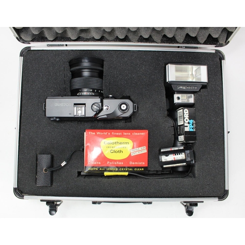 911 - Photographic interest. A Fuji GW670 II Professional range finder camera in box with accessories.