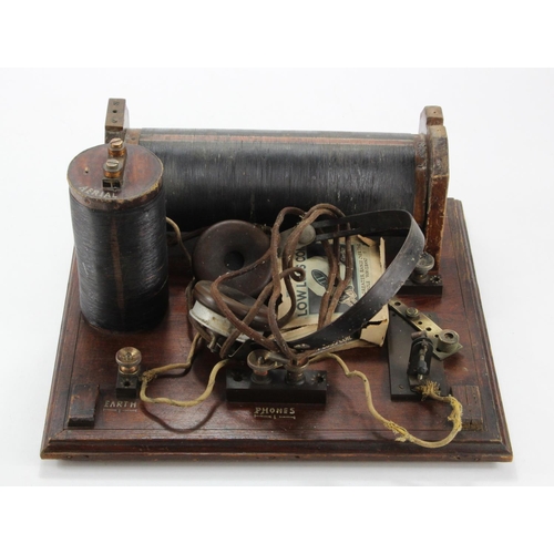 938 - Coil radio & aerial, mounted on a mahogany base, circa early to mid 20th Century, with a pair of hea... 